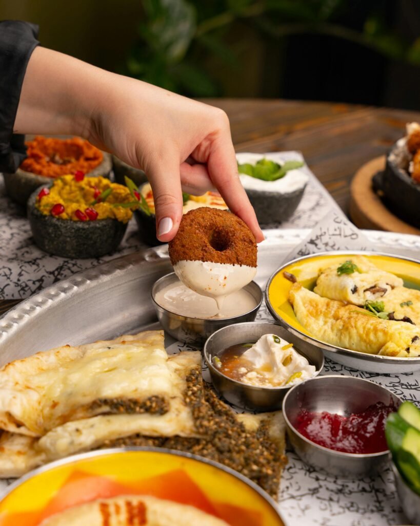 A vibrant display of a traditional South Indian breakfast featuring dosa, vada, and assorted chutneys.